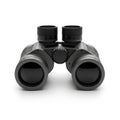 Black modern binoculars with a textured grip and large lenses on a white background optics Royalty Free Stock Photo