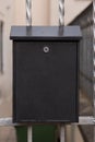 Black modern metal mailbox on outside doors. Royalty Free Stock Photo