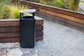 black modern trash bin in the park. Royalty Free Stock Photo