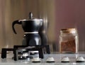 Black moka, the traditional italian coffee maker, with a glass jar full of coffee Royalty Free Stock Photo