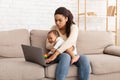 Black Mother With Baby Toddler Working On Laptop At Home