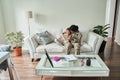 Black mother soldier reading book with son at home Royalty Free Stock Photo