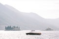 Black motor yacht sails past the island of St. George in the Bay of Kotor. Montenegro