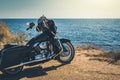 Black motorcycle on beautiful seacoast and blue sky onward. Prairie, steppe, summer. Royalty Free Stock Photo