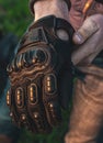 Black motorcycle gloves guy puts on his hands for safety close up Royalty Free Stock Photo