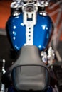 Black motorcycle seat on a blue bike