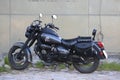 Black motorcycle WELS Trophy WQ-250 near wall of building. Left view