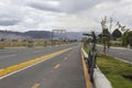 A black Mountain Bike into a bike path near to a new highway street at city outdside with mountains and buildings at background