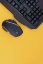 Black mouse, keyboard isolated on a yellow background, top view. Flat lay gamer background Royalty Free Stock Photo
