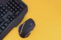 Black mouse, keyboard isolated on a yellow background, top view. Flat lay gamer background Royalty Free Stock Photo