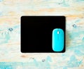 Black mousepad with blue mouse Royalty Free Stock Photo