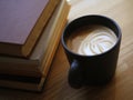 Black mug with coffee drink with milk