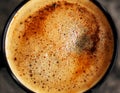 A black mug of hot, aromatic coffee with cinnamon, which is well invigorated in the early morning