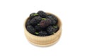 Black mulberry berries in a wooden bowl