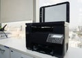 Black multifunction printer in office