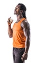 Black muscular male model spraying cologne Royalty Free Stock Photo