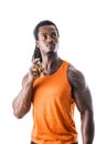 Black muscular male model spraying cologne Royalty Free Stock Photo