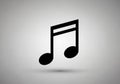 A black musical note icon, commonly known as an eighth note or quaver, is centered on a light grey Royalty Free Stock Photo