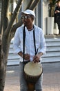 Black musician playing drum on the street in Victoria and Alfred waterfront area in Cape Town, South Africa Royalty Free Stock Photo