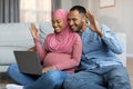 Black Muslim Spouses Expecting Baby Making Video Call With Laptop At Home Royalty Free Stock Photo