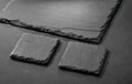 Black natural stone coasters on gray background