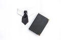 Black necktie and book with black leather cover isolate on white background Royalty Free Stock Photo