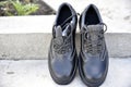 Black new work boots on the street during the day Royalty Free Stock Photo