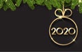 Black 2020 New Year background with fir branches and gold glossy Christmas ball