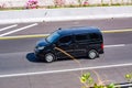 Black Nissan evalia or NV200 van driving fast on trans jawa highway toll road