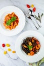 black noodles with mussels, shrimp, tomatoes and herbs top view Royalty Free Stock Photo