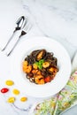 black noodles with mussels, shrimp, tomatoes and herbs top view Royalty Free Stock Photo