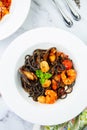 black noodles with mussels, shrimp, tomatoes and herbs top view Royalty Free Stock Photo