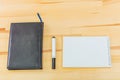 Black notebook with black marker on the table top view. At the office desk is a black notebook. Office bureau flat to Royalty Free Stock Photo