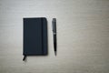 Black notebook and pen on the table . Royalty Free Stock Photo