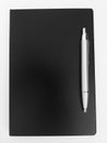 Black notebook and a silver pen Royalty Free Stock Photo