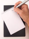 Black notebook, silver pen and a woman's hand Royalty Free Stock Photo