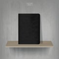 Black notebook on wooden shelf with vintage concrete wall background. Vector