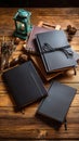 Black notebooks, vintage lantern, and pine cones resting on a rustic wooden tabletop surface in moody studio lighting Royalty Free Stock Photo