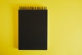 black notepad spiral on yellow background mockup