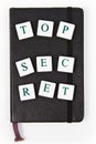 Black notepad with top secret message