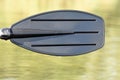 Black oar on the lake with drop of water Royalty Free Stock Photo