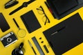 Black objects from the office on a yellow background. Work and creativity. Top view. Royalty Free Stock Photo
