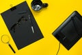 Black objects from the office on a yellow background. Work and creativity. Top view. Royalty Free Stock Photo