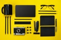 Black objects from the office on a yellow background. Work and creativity. Top view. Royalty Free Stock Photo