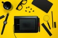 Black objects from the office on a yellow background. Work and creativity. Top view. Royalty Free Stock Photo