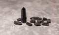 Black obsidian crystal wand. Crystals of stone black tourmaline. Royalty Free Stock Photo