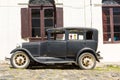 Black and obsolete car on one of the cobblestone streets, in the city of Colonia del Sacramento, Uruguay. It is one of the oldest Royalty Free Stock Photo