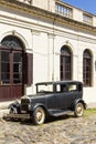 Black and obsolete car on one of the cobblestone streets, in the city of Colonia del Sacramento, Uruguay. It is one of the oldest Royalty Free Stock Photo