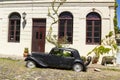 Black and obsolete car on one of the cobblestone streets, in the city of Colonia del Sacramento, Uruguay. It is one of the oldest Royalty Free Stock Photo