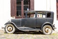 Black and obsolete car on one of the cobblestone streets, in the city of Colonia del Sacramento, Uruguay. It is one of the oldest Royalty Free Stock Photo